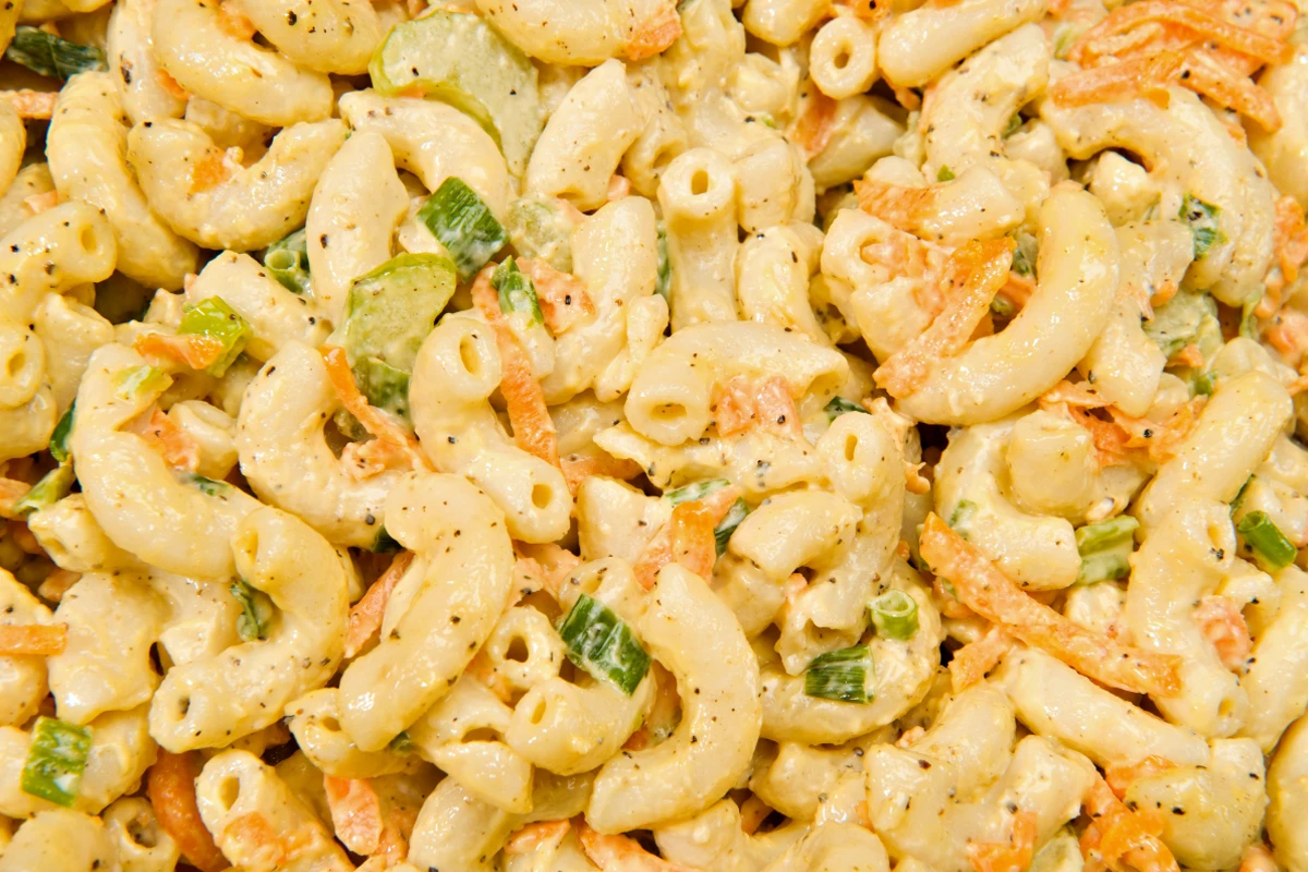 Close-up of Hawaiian Mac Salad, featuring elbow macaroni mixed with mayonnaise and diced vegetables, speckled with black pepper.