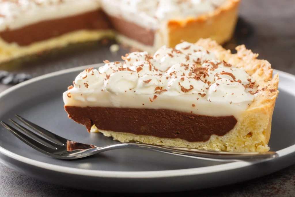 Slice of haupia cake on a plate with a fork