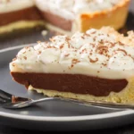 Slice of haupia cake on a plate with a fork